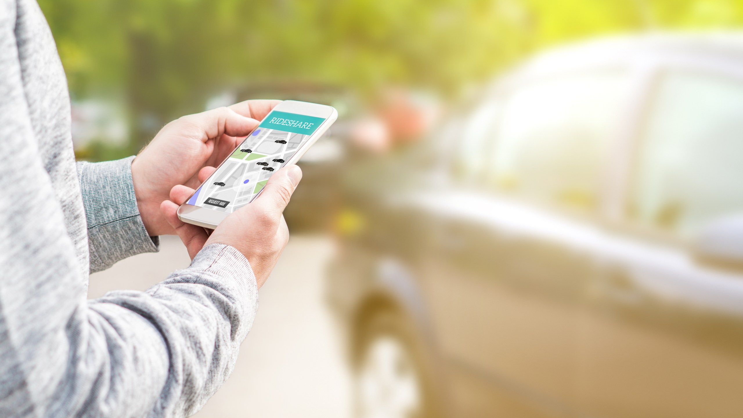 Person using Travella app near car